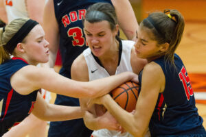 CHRIS ANDERSON, PHOTO - The Journal. Harlem's Klairissa Boisvert (10) battles two Blue Thunder opponents for control of the ball during the game against Belvidere North on Dec. 6. 