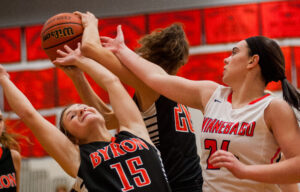 Winnebago's Kiah Garrigan tries to steal a rebound from Byron's Rachel Bonnell (15) and Bailey Burrows (20) in the first quarter during their game in Winnebago Monday, Jan. 11. Their 64-53 win put them at 7-1 in the BNC.  Photo by Randy Stukenberg