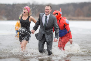 Kim Louis (from left), Mark Batty and Ray Gutierrez from Rochelle Community Hospital feel the cold during the annual 2016 Special Olympic Polar Plunge held at Olson Lake in Rockford, IL. on Saturday, Mar. 5, 2016. Erik Anderson | The Post Journal