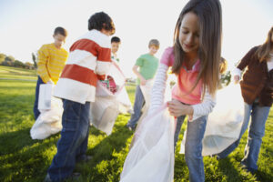 Kids Picking Up Trash in Field