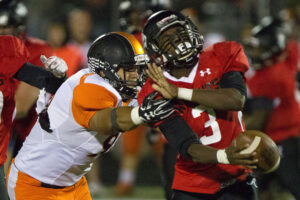 CHRIS ANDERSON PHOTO - The Journal Harlem's Octavio Galvez (96) pulls down Auburn's Quay Thompson (3) during the Huskies' loss to the Knights on Oct. 7. 