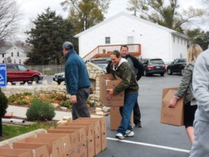 MARIANNE MUELLER, PHOTO - The Herald. Volunteers line boxes up outside the Old Stone Church ready to be picked up by area families. 