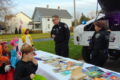 ANNE EICKSTADT PHOTO Belvidere Republican
	Officer Tim Blankenship and Officer Julie Kirk meet costumed kids in the community with candy and books the kids can keep.
