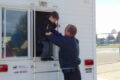 ANNE EICKSTADT PHOTO Belvidere Republican
	Firefighter Chad Cunningham assists a Seth Whitman Elementary School second grader to ‘escape’ through the window of the BFD Fire Safety House.