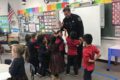 ANNE EICKSTADT PHOTO Belvidere Republican
	Officer Tim receives many ‘high fives’ from the kids for everything he has done during his visit to the class.