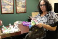 ANNE EICKSTADT PHOTO Belvidere Republican
	Volunteer Melissa Perez fills a donated purse with items to empower a woman to look and feel her best.