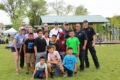 ANNE EICKSTADT PHOTO Belvidere Republican
	Police, firefighters, Jen Jacky, executive director of Belvidere Family YMCA, and the kids of the kickball teams join together for a group photo during halftime.