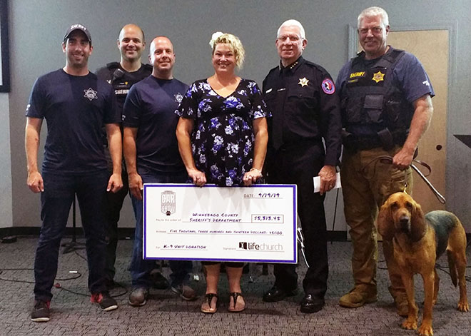 Life Church in Roscoe presents donation to Winnebago County Cops, Cars and K9s