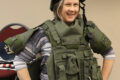 Citizens Police Academy student Chris Gardner tries on the SWAT protective vest and helmet.