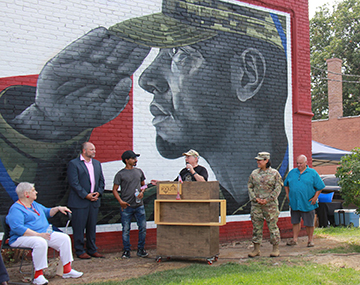 Uniting in tribute: RACVB hosts CRE8IV mural dedication, flag-raising ceremony; Community gathers at Veterans Memorial Circle to honor local veterans
