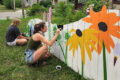 COURTESY PHOTO The Herald
	Asia Michaela Peters and her cousin Raven Wilks create a mural on Haskell Street.
