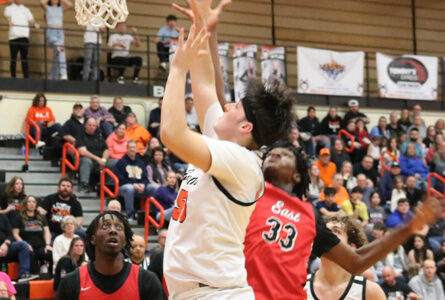 ALEX GARY The Journal
	Harlem's Tim Wessels powers past Rockford's Marquis Goldsmith for two points in the Huskies' 56-51 win on senior night.
