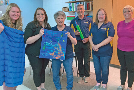 SUBMITTED PHOTO The Gazette
	Pecatonica Rotary Club members pose with Pe-catoncia Elementary School staff to show off some of the items that they now have access to.