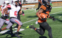 JOURNAL STAFF PHOTO The Journal
	Harlem senior Jahmani Muhammad races away from the Auburn defense for the fourth of his five touchdown runs in Harlem's 40-6 win. The game started Friday night but had to be finished Saturday afternoon after a fight behind the stands caused a panic.