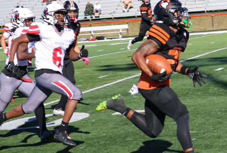 JOURNAL STAFF PHOTO The Journal
	Harlem senior Jahmani Muhammad races away from the Auburn defense for the fourth of his five touchdown runs in Harlem's 40-6 win. The game started Friday night but had to be finished Saturday afternoon after a fight behind the stands caused a panic.