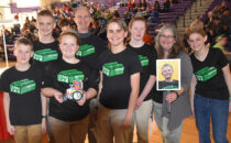 SUBMITTED PHOTO The Gazette
	Team 2x4 a successful robot run. From left: Mason Williams, Tim Walton, Bethany Walton, Coach Kent Walton, Evan Schneider, Halee Williams, Coach Heather Schneider, Isaac Bentley (in the photo being held), and student mentor Kelby Schneider celebrate.