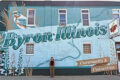 SUBMITTED PHOTO Tempo
	On July 18, Byron held a ribbon cutting for the completion of their fourth downtown mural, “Community and Connection,” by artist Nicole Arand (center).
